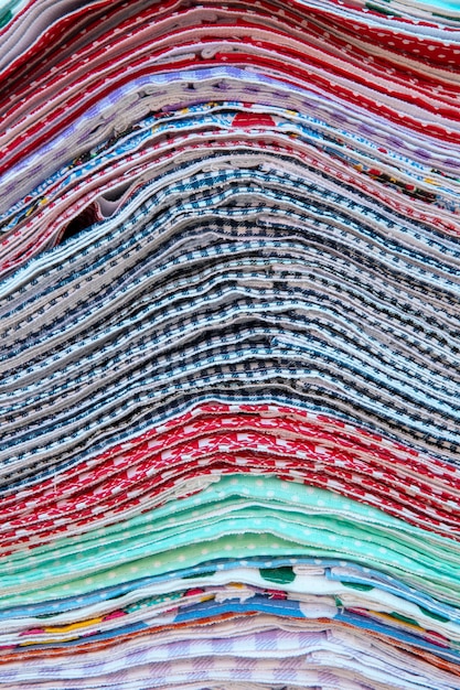 Pile of multicolor kitchen towel to sale on open air market