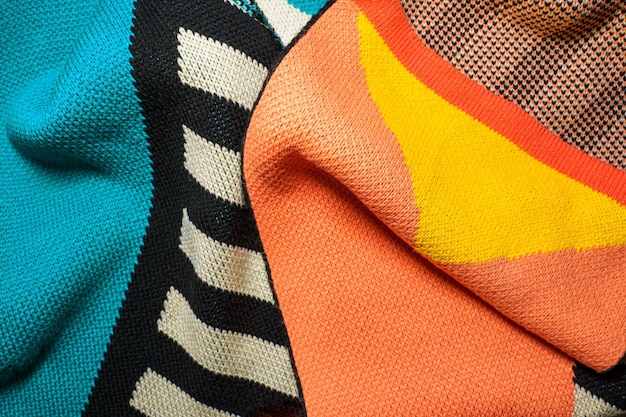 A pile of multicolored knitted fabrics