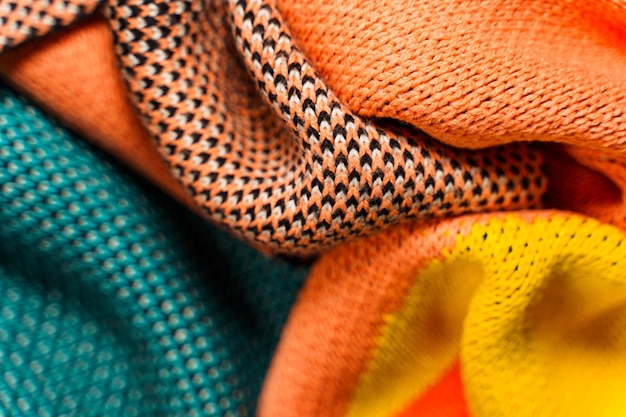 A pile of multicolored knitted fabrics