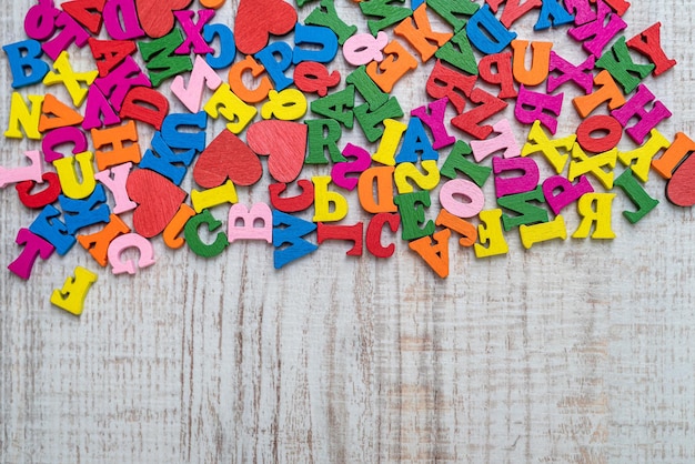 Pile of multicolored small wooden letters for primary education