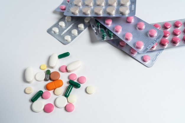 Pile of multicolored vitamins and pills isolated on a white background