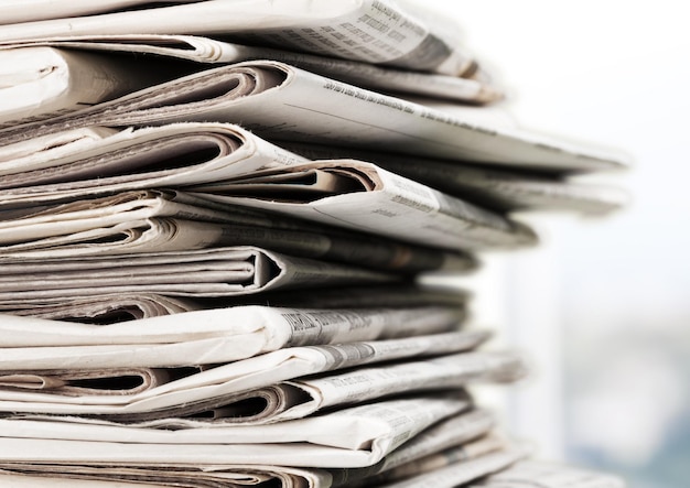 Pile of newspapers on background, close-up view