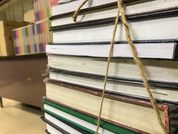 Pile of old books with rope background