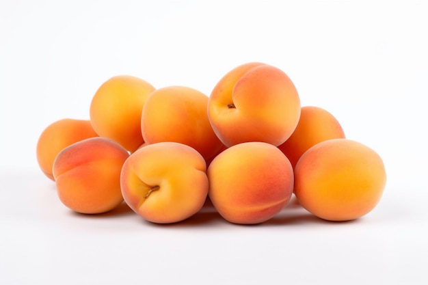 A pile of orange apricots on a white background