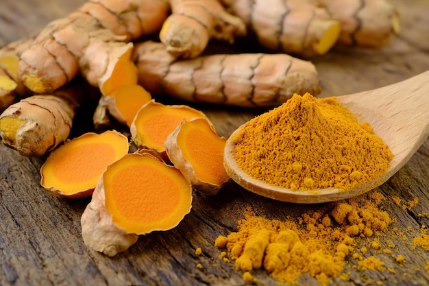 a pile of orange spices with a spoon of orange substance