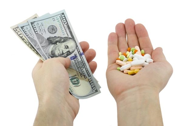 Pile of pills and money bills in hands