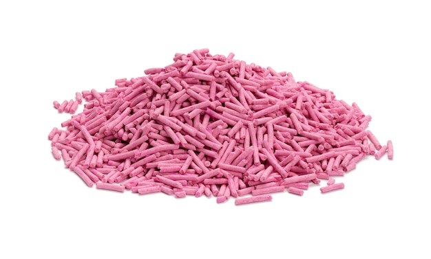 Pile of pressed pink cat litter isolated on white background. Granules with scent