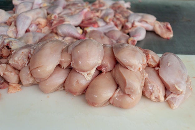 A pile of raw chicken on a cutting board