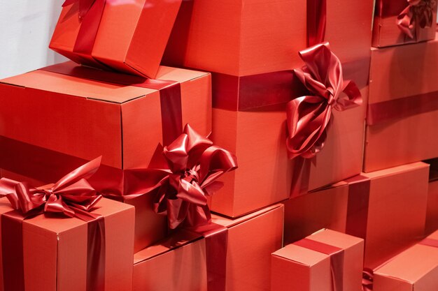 Pile of red boxes with bows gifts