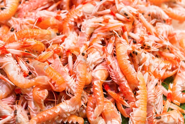 Pile of red fresh shrimps at the market. Seafood texture for background