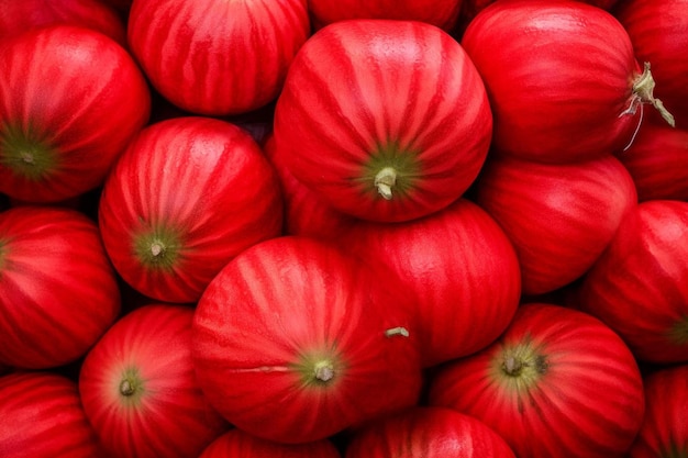 a pile of red tomatoes with green stems and green stems