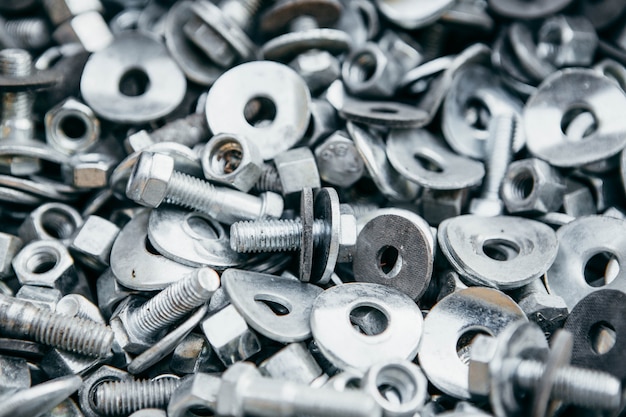 A pile of silver bolts and nuts