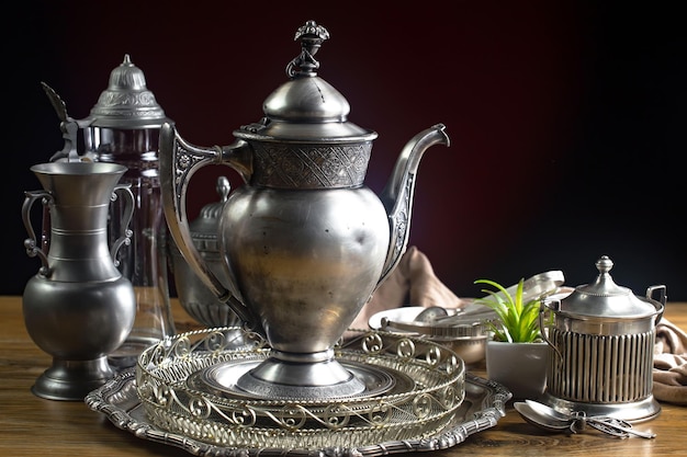 A pile of silverware with a woman on the top of it.