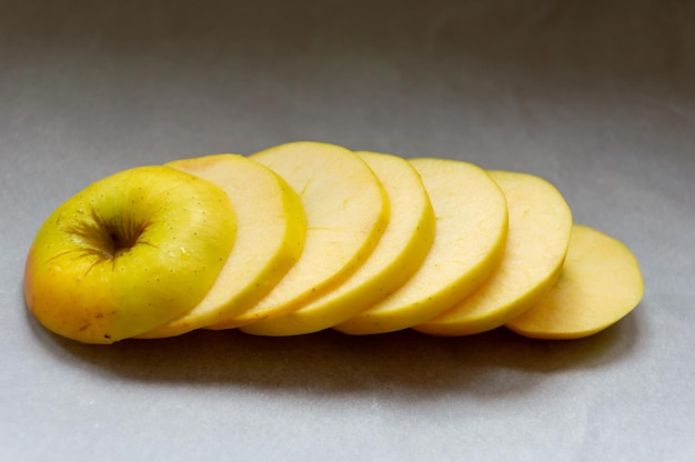 A pile of sliced apples on a table