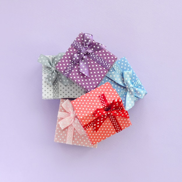 Pile of a small colored gift boxes with ribbons lies