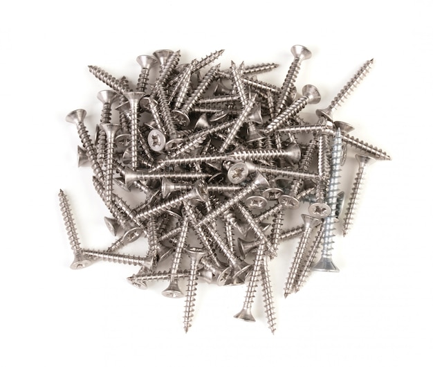 Pile of steel screws on white background