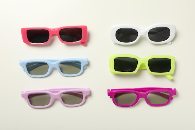 A pile of sunglasses with on a light background