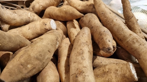 A pile of sweet potatoes with one that says'sweet potatoes '