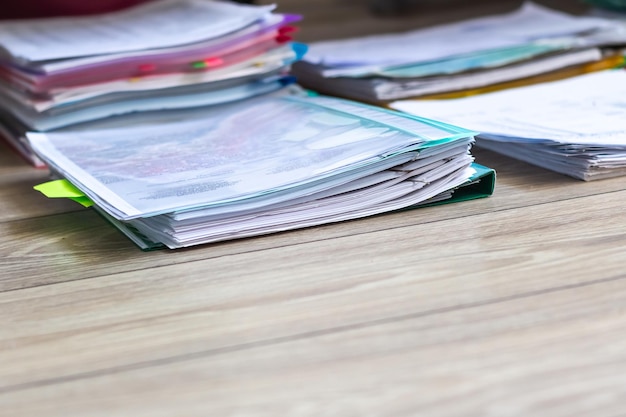 Pile of unfinished documents on office desk Stack of business paper