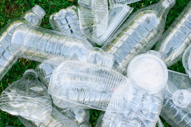 Pile of used plastic bottles on the grass the concept of ecology Waste separation concept