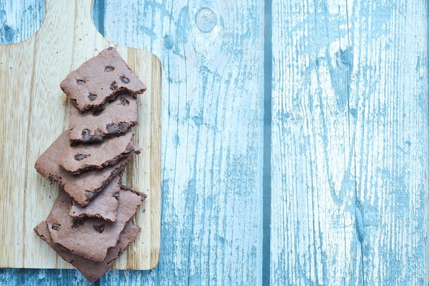 A pile of white chocolate chip on chopping board with copy space