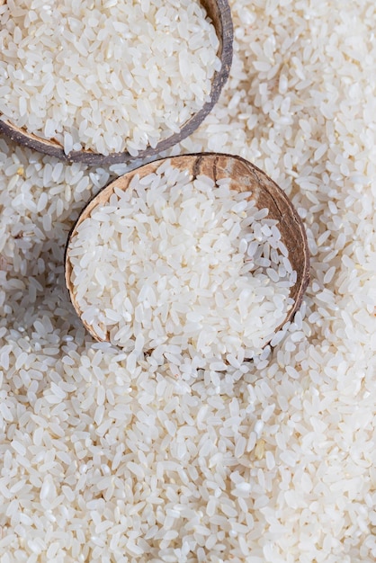 A pile of white rice on the kitchen table in a wooden plate