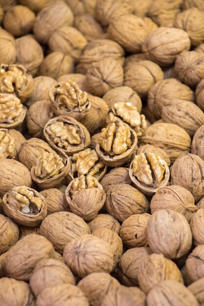 Pile of whole walnuts with hard nutshells