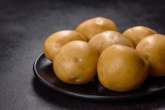 A pile of young potatoes on the table The benefits of vegetables