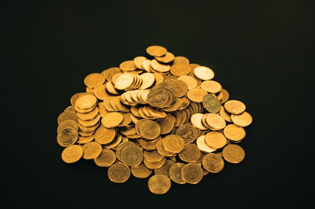 Piles of coins on black background