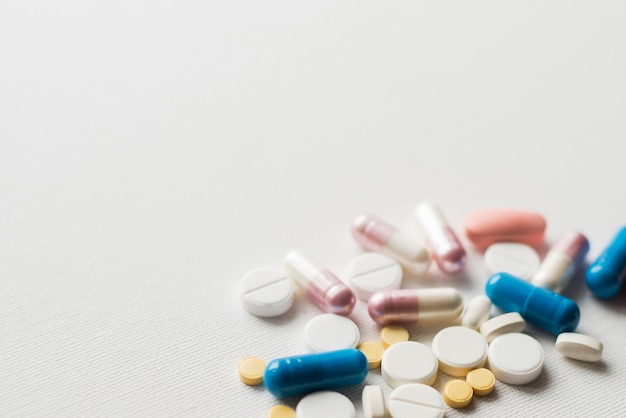 Piles of pills and capsule on white, isolated. 