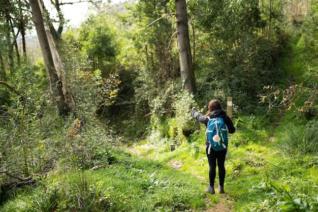 Pilgrim brunette woman doing the Camino de Santiago Hike way of st james