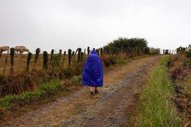 Pilgrim walking on the countryside road at Rainy day during the Chemin du Puy France