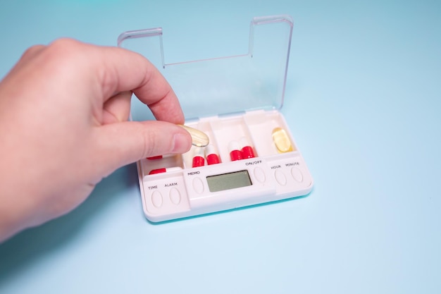 Pill box daily take a medicine, with colourful of pills, tablets, and capsules.