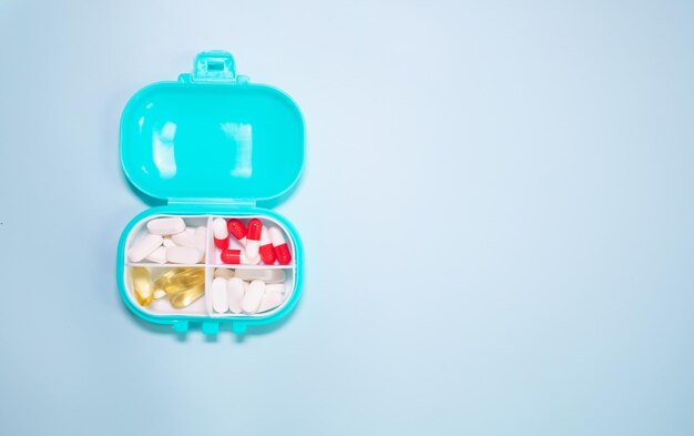 Pill box daily take a medicine, with colourful of pills, tablets, and capsules.