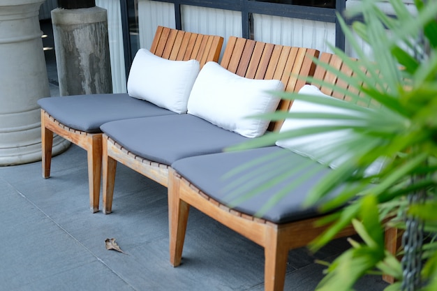 Pillow cushion on wooden chair in hotel resort for relaxing outdoor