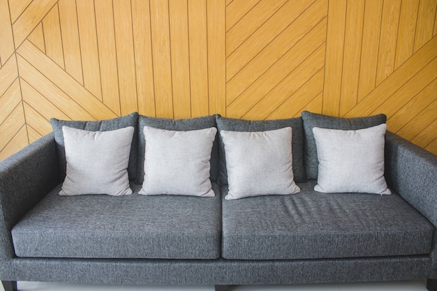 Pillow decoration on sofa with wood background