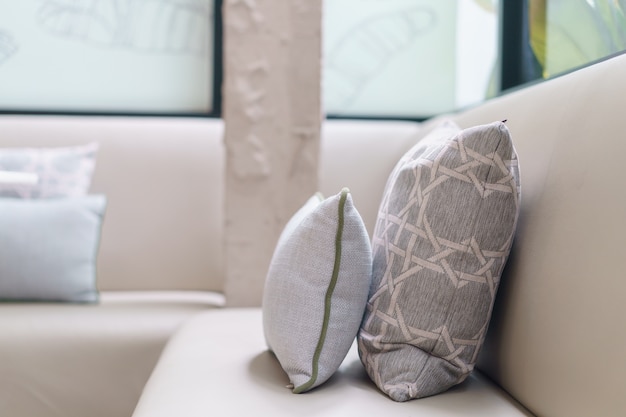 Pillows on sofa decoration in living room interior.