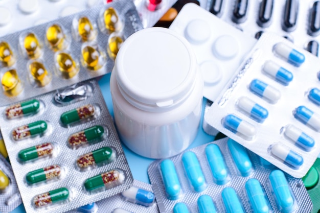 Pills in foil package and plastic bottle in the middle