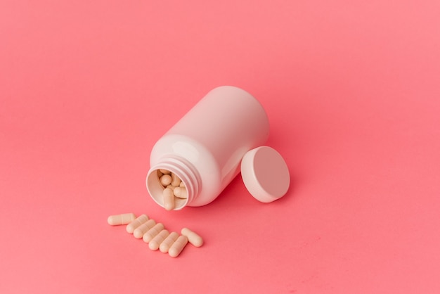 Pills isolated on pink background