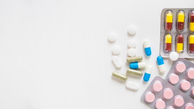 Pills and medicine blister on white background