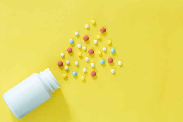 Pills and medicine bottles on a yellow backgroundAll kinds of drugs to be put into the medicine