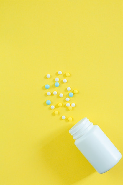 Pills and medicine bottles on a yellow backgroundAll kinds of drugs to be put into the medicine