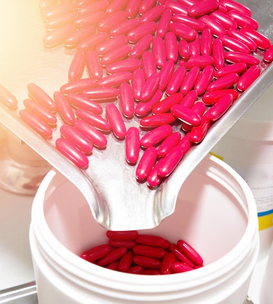 Pills on medinine tray in drug store in health concept