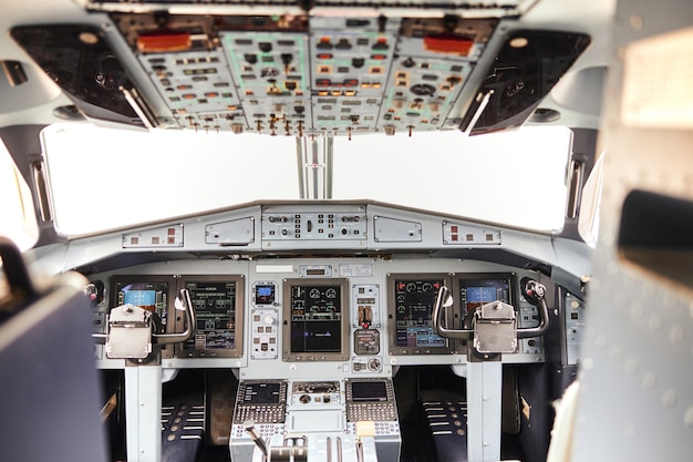 Pilot cabin in modern passenger airplane jet. Empty interior. Dashboard, air navigation and steering wheel. Civil commercial aviation. Air travel concept