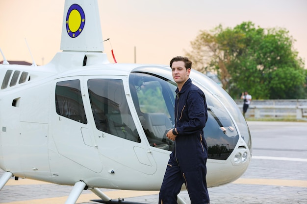 Pilot with a helicopter in airplane airport