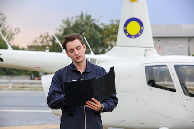 Pilot with a helicopter in airplane airport