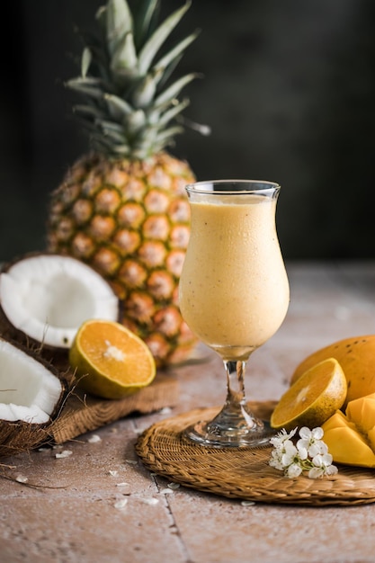 Pina colada pineapple cocktail or Lassi on a rustic wooden table