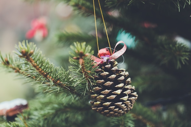 Pine cone decoration on Christmas tree Diy ideas for children Selective focus