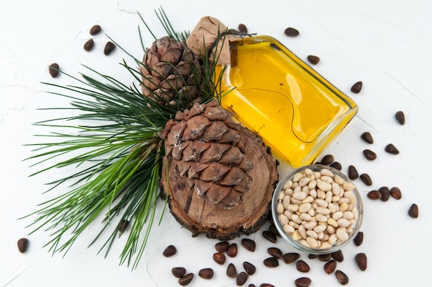 Pine cones and cedar products nuts and cedar oil View from above On a gray background