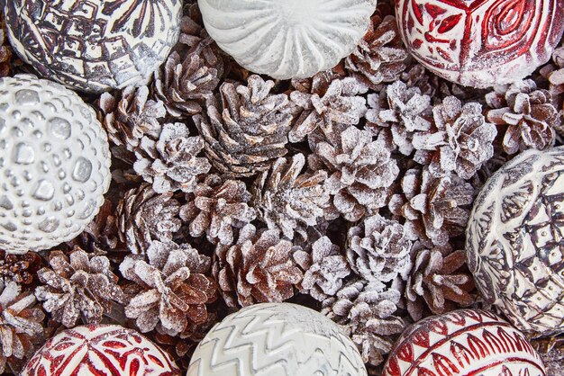 Pine and fir cones and Christmas tree glass balls toys covered with snow and frost